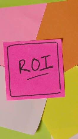 Vertical-Video-Business-Concept-Of-Revolving-Sticky-Notes-With-ROI-Written-On-Top-Note-1